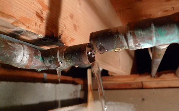 Broken pipe leaking under the sink.