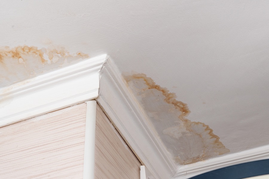 Neighbors have a water leak, water-damaged ceiling, close-up of a stain on the ceiling.