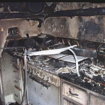 A severely damaged kitchen due to a fire.