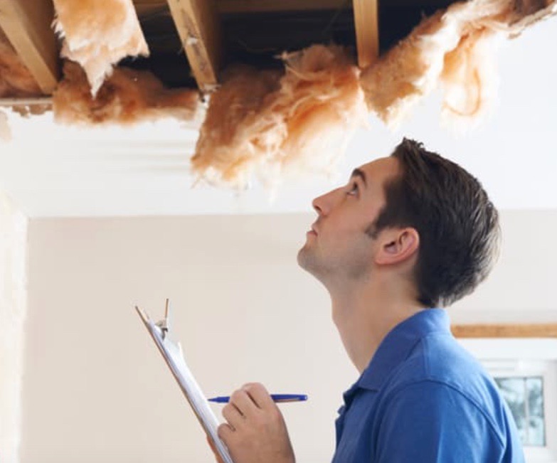 A man from the water damage company doing some inspection for estimates.